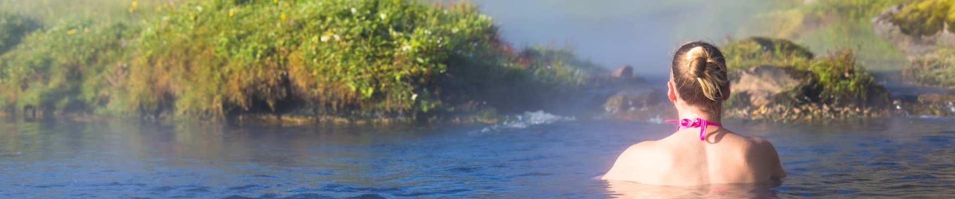 iceland hot springs - Girl enjoying bathing in a lagoon