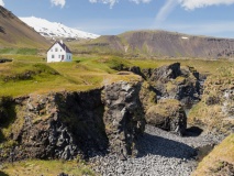 Snæfellsnes peninsula, Small farmhouse standing close to some cliffs by the sea